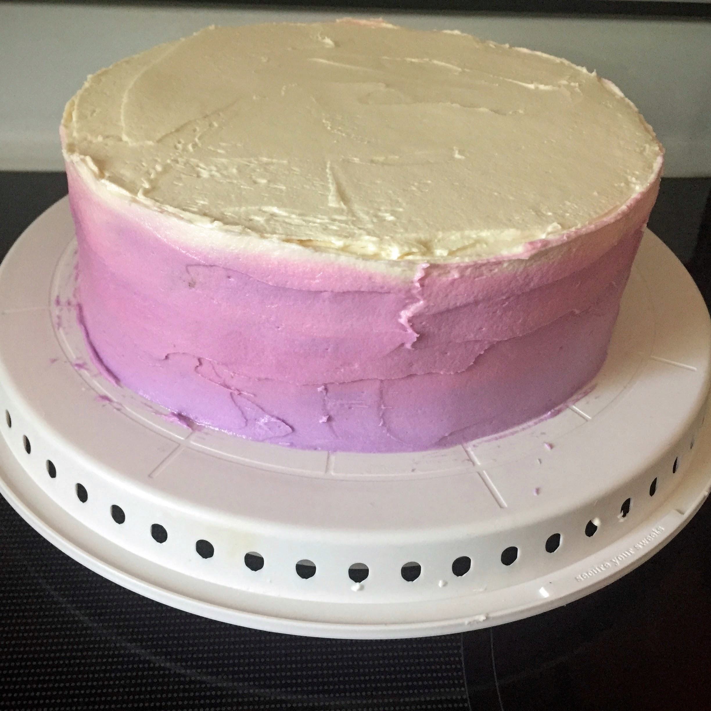 Continue to use the icing spatula to even out the layers of frosting, smoothing until the ombre is to your liking.